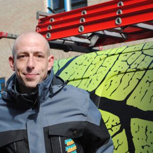 Werknemer Traas Nederland staat voor een bus